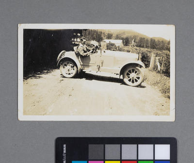 [Frederick Raynor Pinny in unidentified British or European automobile on rural road]