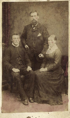 Photograph of two men and a woman
